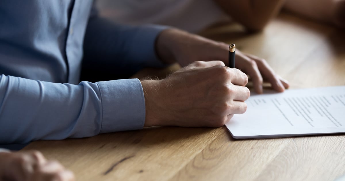 Someone signing a document