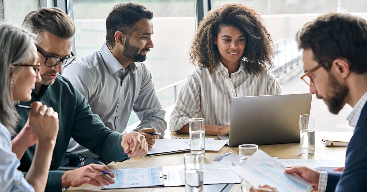 Employees collaborate in work meeting