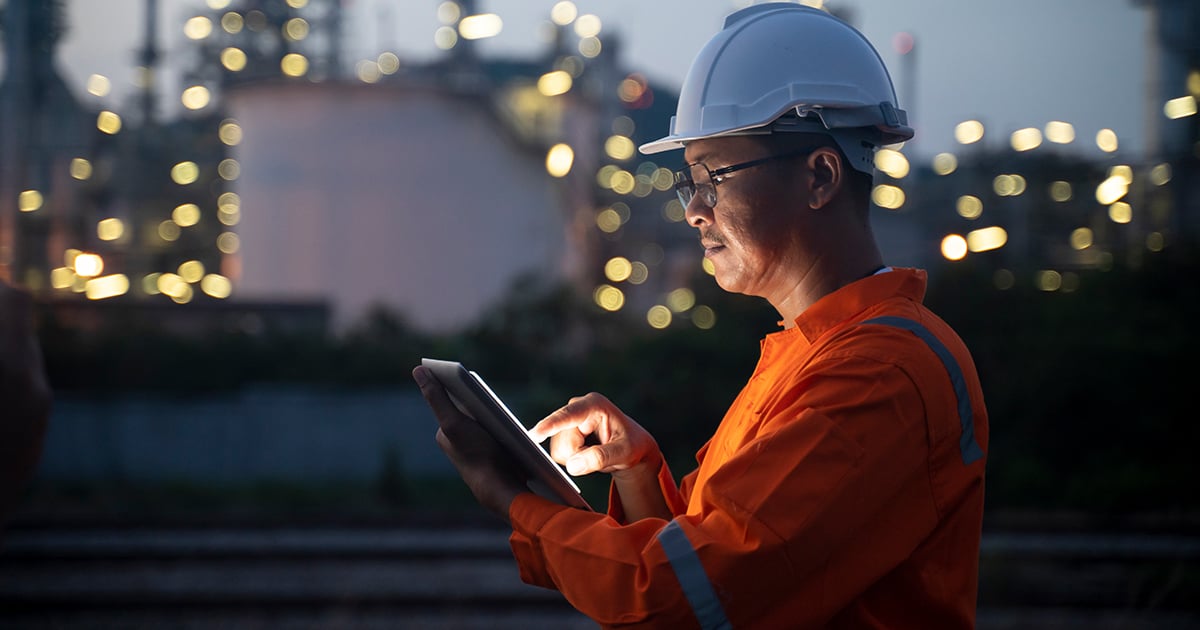 Someone in the oilfield looking at a tablet