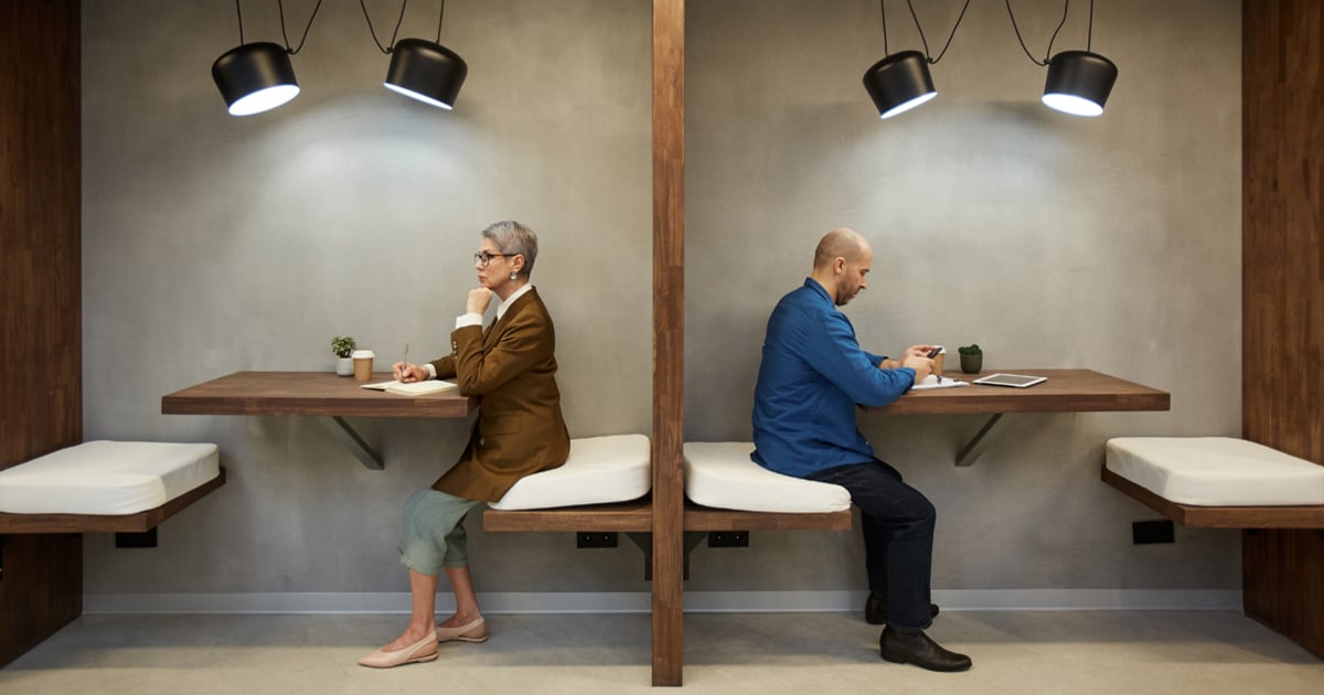 Two people in separate tables giving space to each other